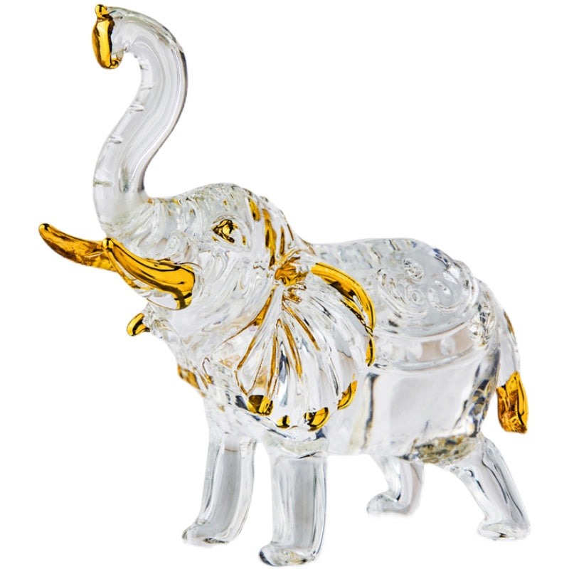 Figurine éléphant cristal transparent avec accents dorés – symbole de chance posé sur marbre noir