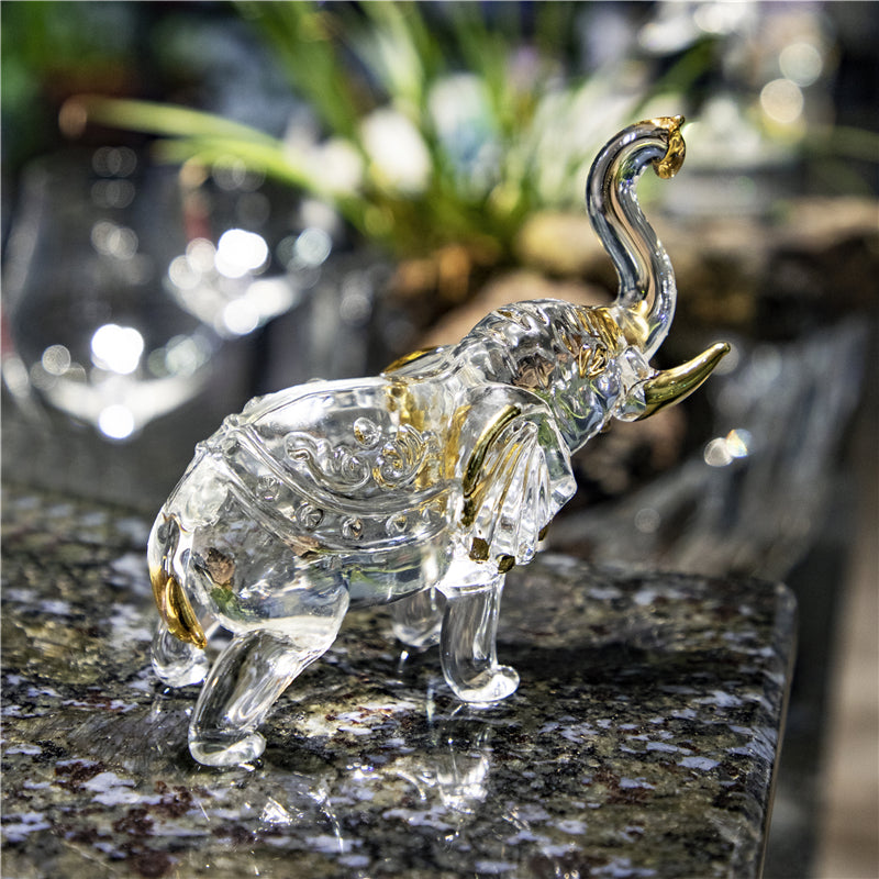 Figurine éléphant cristal transparent avec accents dorés – symbole de chance posé sur marbre noir